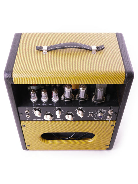 Swart Atomic Space Tone Amplifier in yellow, featuring a stylish black and gold cover, made in the USA, 2008.