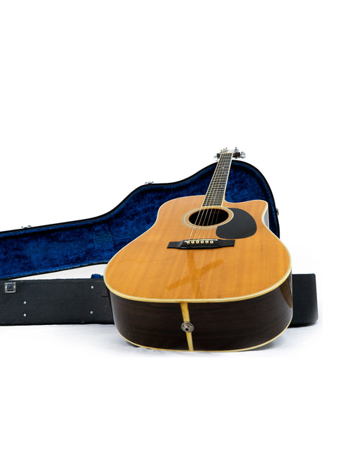 Takamine EF 360SC guitar, made in Japan in 1988, placed in a case on a white surface.