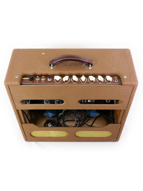Tan guitar amplifier with a brown leather handle, the Victoria Victorilux 3x10 Combo from the USA, made in 2005.