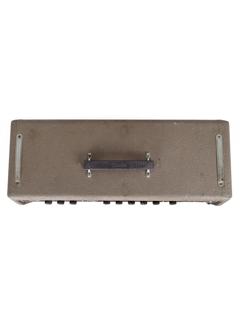 The 1961 Fender 6G12A Concert Amp sits atop a white surface, embodying a timeless vintage aesthetic and musical history.