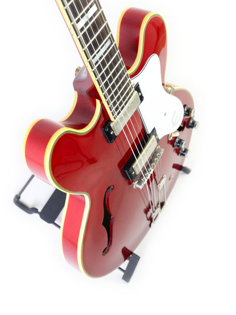 The Epiphone 50th Anniversary 1962 Sheraton E212T Reissue, a red guitar with a white body and sleek black neck, stands out beautifully.