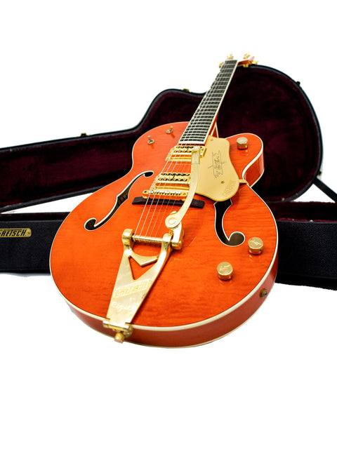 The Gretsch G-60S in orange, emphasizing its stylish design and quality, made in Japan in 2011 for a classic look.