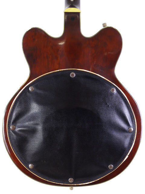 The back of a 1967 Gretsch 6122 Chet Atkins guitar, elegantly covered in leather, showcasing its vintage charm.