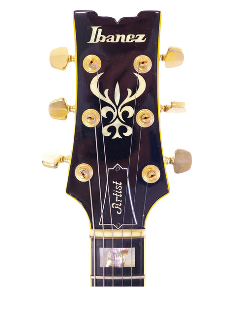 The headstock of an Ibanez Artist AS200 guitar, made in Japan in 1981, prominently displaying a gold logo.