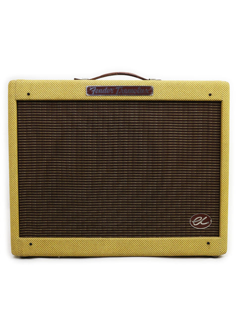 The image features a yellow Fender EC Tremolux Combo Amplifier, model year 2014, highlighting its vibrant color and classic style.