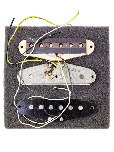 Three classic guitar pickups from a 1968 USA Fender Stratocaster, showcased on a foam board.