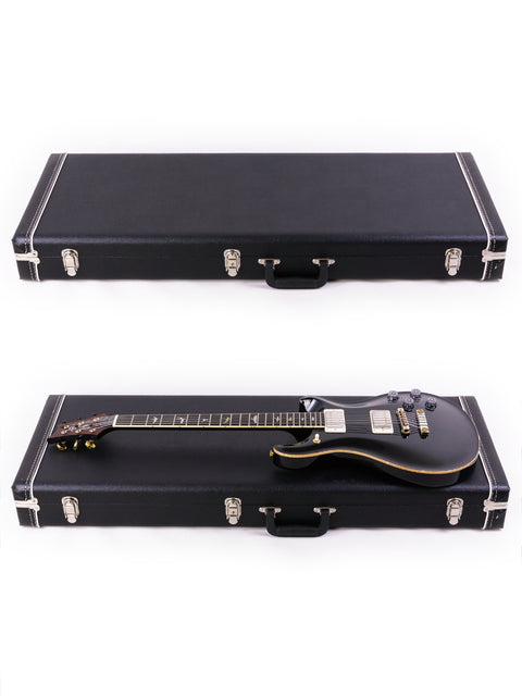 Two black electric guitars, one a 2016 PRS McCarty 594, displayed in a case on a clean white background.