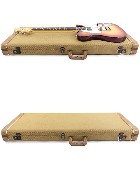 Two cases, one holding a Fender American Standard Telecaster guitar, the other an empty case, showcasing musical gear.