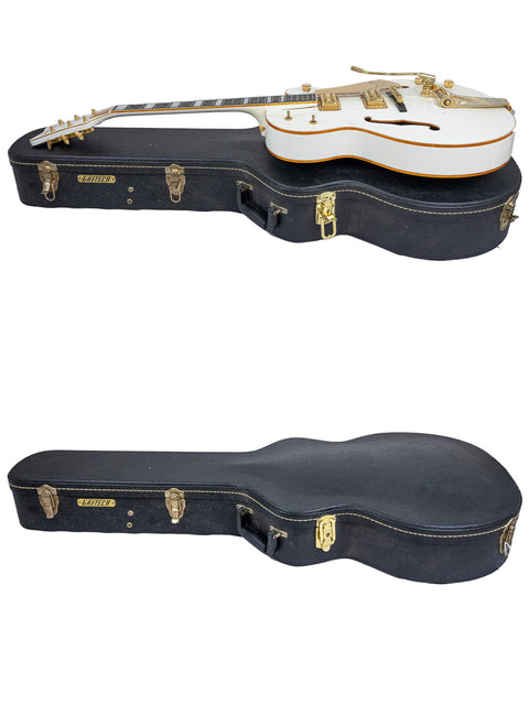 Two elegant white guitars with gold accents are displayed in a black case, identified as the Gretsch G7593 White Falcon, Japan 2012.