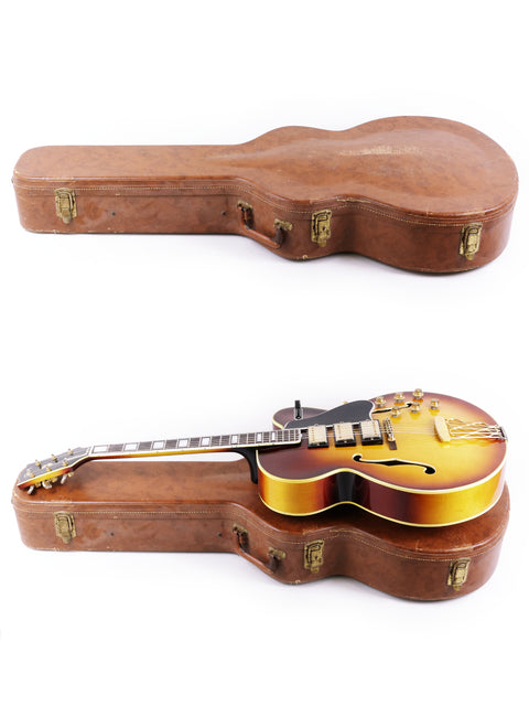Two guitars, featuring a Gibson ES-5 Switchmaster 1959, elegantly displayed in a case on a white backdrop.