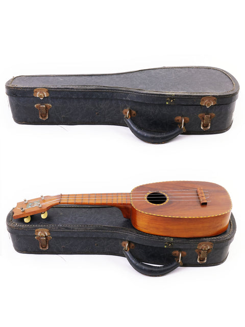 Two ukulele guitars in a case, featuring a vintage Kamaka Pineapple Style #3 from 1928, set against a white background.