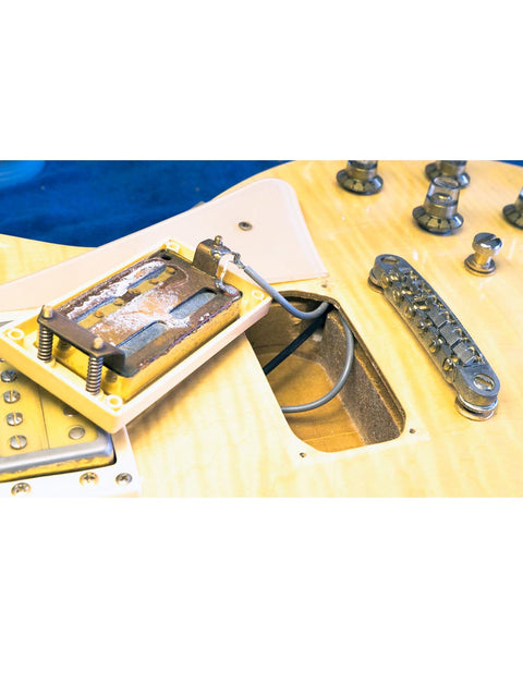 Univox Gimmie U-1988 guitar (Japan, 1974-75) with a striking metal cover and bridge, highlighting its distinctive craftsmanship.