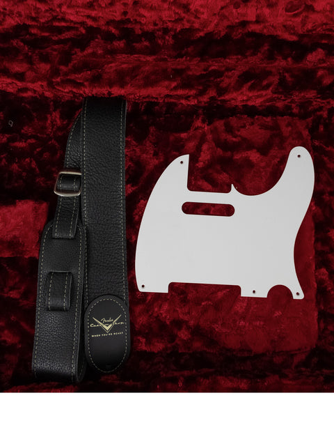 Velvet case containing a white guitar pick guard and strap, showcasing the Fender Custom Shop 30th Anniversary ’51 Nocaster.