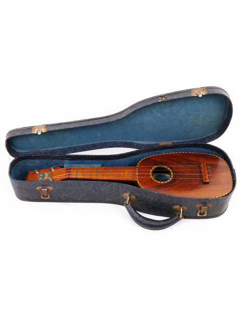 Vintage 1928 Kamaka Pineapple Style #3 ukulele in a blue case, showcasing its wooden craftsmanship.
