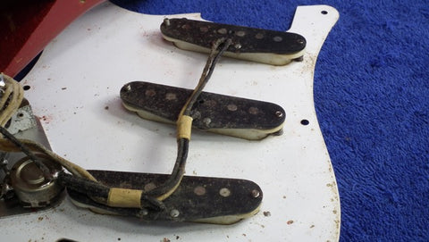 Vintage 1957 Fender Stratocaster, Dakota Red finish, equipped with four pickups and a pickup selector switch.