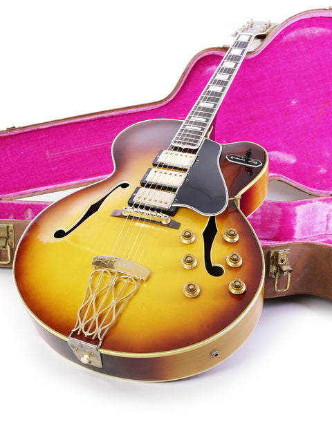 Vintage 1959 Gibson ES-5 Switchmaster guitar resting in a vibrant pink case, highlighting its classic design and beauty.