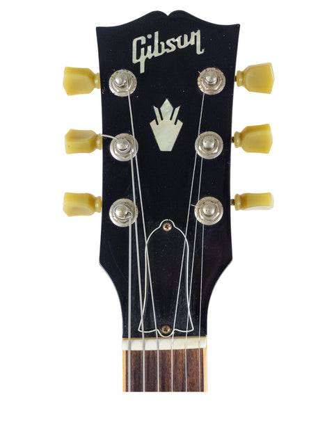 Vintage 1964 Gibson Les Paul Custom guitar, highlighting its iconic features, alongside a 2009 Gibson Custom Shop ES 339.