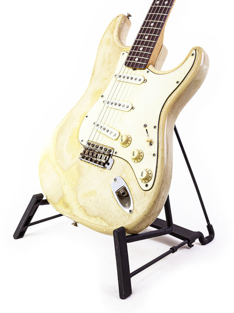 Vintage 1968 Fender Stratocaster in white, beautifully positioned on a black guitar stand.