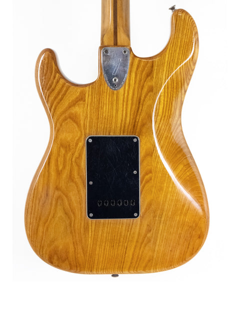 Vintage 1979 Fender Stratocaster, wooden body and black pickguard, a perfect blend of style and sound.