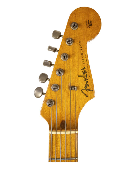 Vintage Fender Stratocaster from 1957, featuring a Dakota Red refinish, exemplifying timeless guitar artistry.