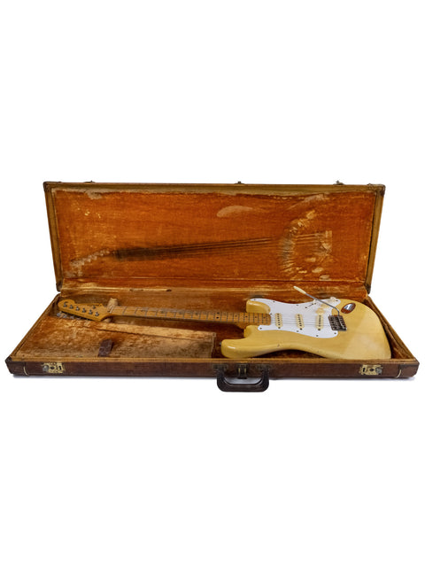 Vintage Fender Stratocaster guitar from 1959, blond with a maple neck, elegantly housed in a wooden case.