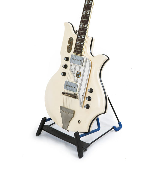 White National Valco Glenwood Model 99 guitar from 1962, elegantly positioned on a blue stand.