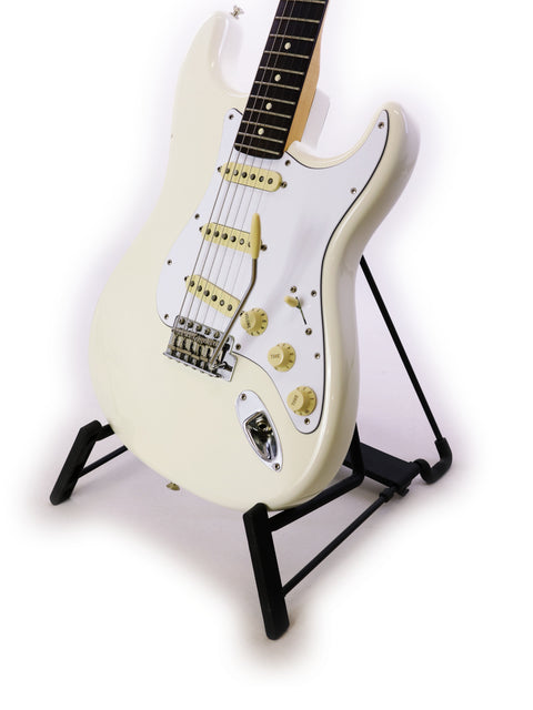 White electric guitar on a black stand, isolated on a white background.