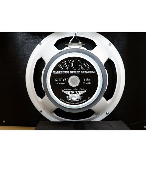 White speaker with a black and white label, representing the PRS Paul Reed Smith 30 Combo Amp made in the USA, 2010.