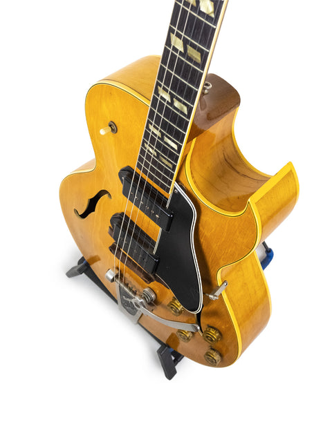 Yellow 1953 Gibson ES 175 DN guitar with a black pick guard, highlighting its vintage charm and iconic design.