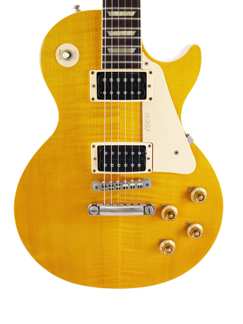 Yellow Gibson Les Paul Standard guitar, 1960 Reissue model from 1991, highlighting its iconic shape and vintage appeal.