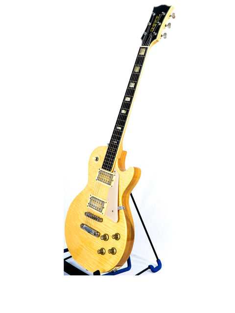Yellow electric guitar, Univox Gimmie U-1988, Japan 1974-75, showcased on a stand, highlighting its vintage design.