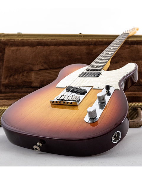 beautifully crafted sunburst Fender Telecaster guitar from 2002, resting in a wooden case, perfect for any music lover.