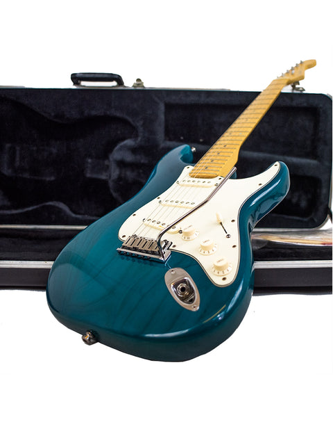 blue Fender American Deluxe Stratocaster electric guitar in a protective case, showcasing its sleek design and craftsmanship.