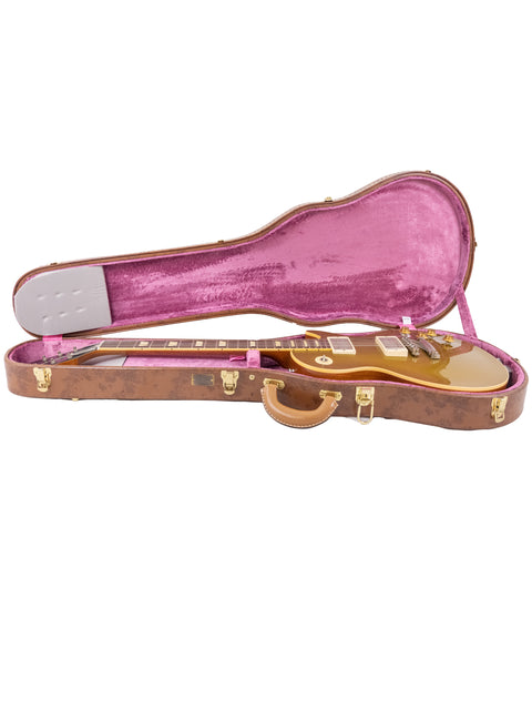 luxurious gold guitar case with a vibrant pink interior, showcasing the Gibson Custom Shop LPR-7 1957 Les Paul Goldtop Reissue.