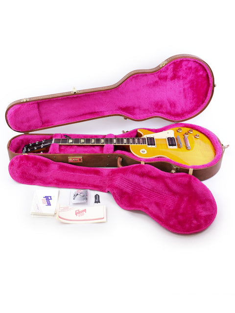 yellow Gibson Les Paul Classic 1960 Reissue guitar in a pink case, showcasing its vibrant color and protective design.