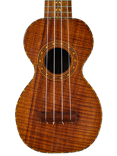 1920s Kumalae ukulele with a beautifully crafted wooden body and neck, representing traditional Hawaiian music heritage.