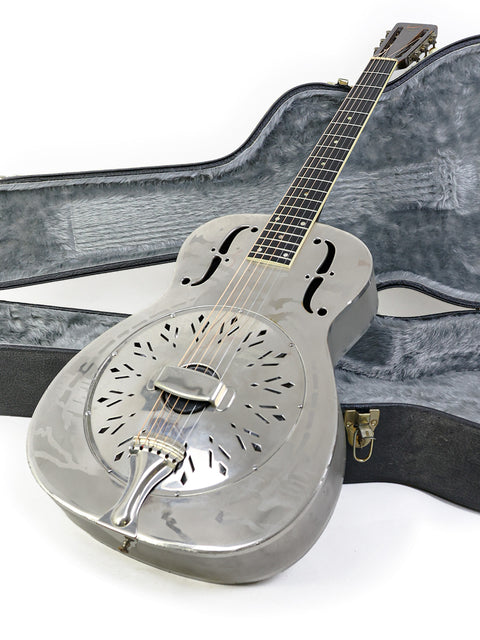 1934 National Style 'O' guitar resting in its case, showcased on a simple white background.