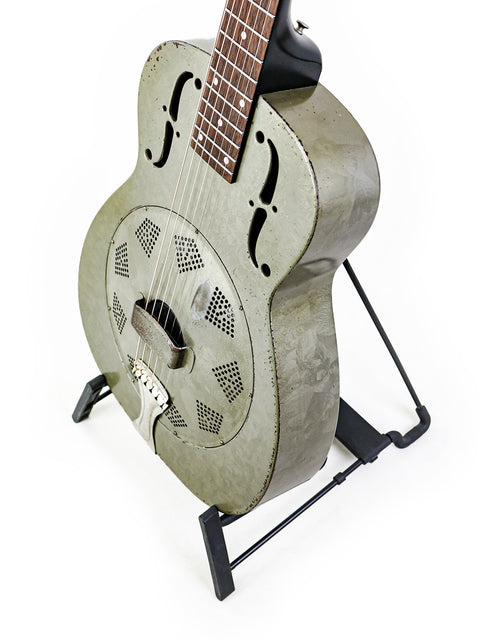 1936 National Duolian Resonator guitar elegantly positioned on a stand with a plain white background.