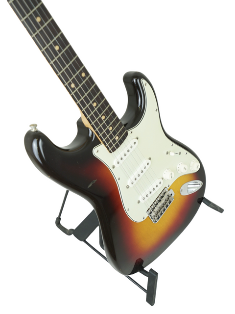 1961 Vintage Fender Stratocaster guitar showcasing a striking black body paired with a vibrant sunburst neck.
