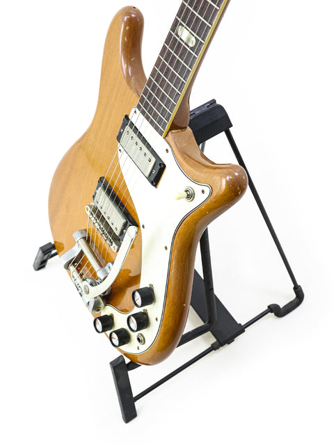 1964 Epiphone Crestwood Custom guitar elegantly positioned on a stand with a stark white background.