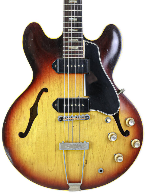 1964 Gibson ES-330TD sunburst electric guitar with a black pick guard, blending vintage charm with striking visual appeal.
