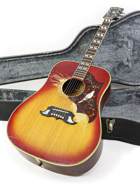 1968 Gibson Dove guitar lying in its case on the floor, emphasizing its vintage style and iconic status.