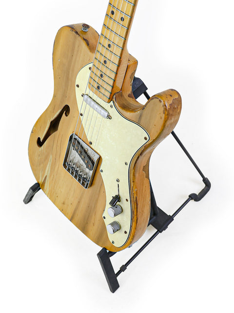 1971 Fender Telecaster Thinline guitar featuring a wooden body, resting on a sleek black stand.