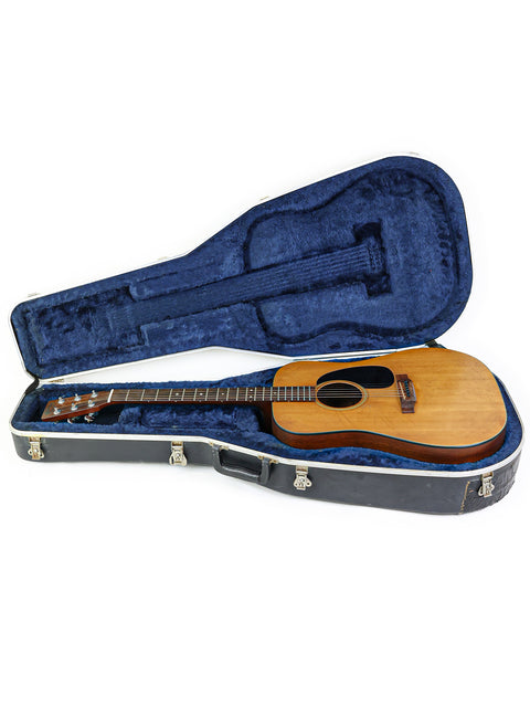 1974 Martin D-18 guitar snugly in its case, set on a simple white background.