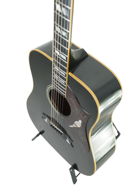 1977 Gibson Dove Custom acoustic guitar in black, highlighting its elegant wooden body and timeless design.