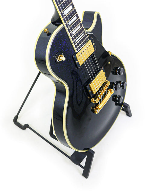 1991 Gibson Custom Shop Les Paul Custom, featuring a black body and gold hardware, showcasing classic design.
