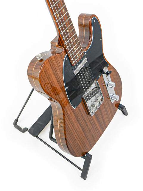 2003 Fender Masterbuilt Telecaster featuring a wooden body and black pick guard, highlighting its unique limited edition design.