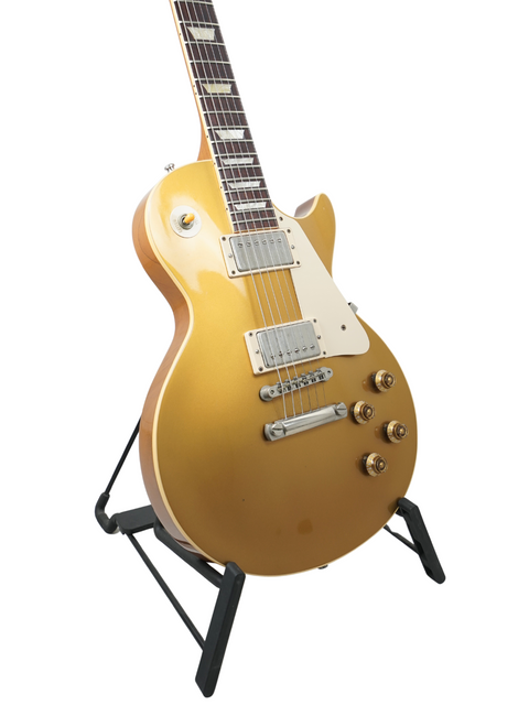 2003 Gibson Les Paul Standard Goldtop, a classic electric guitar with a striking gold finish and vintage vibe.