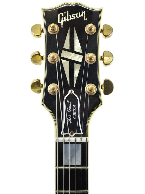 2004 Gibson Les Paul Custom Shop 'Black Beauty' guitar, 1957 reissue, showcasing a sleek black finish and classic style.