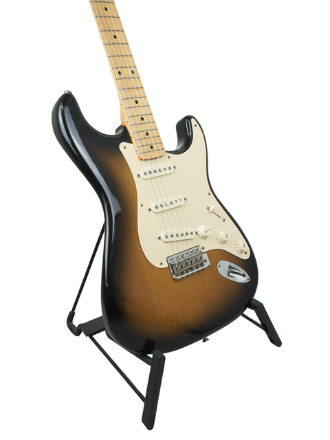 2005 Fender Eric Johnson Signature Stratocaster resting on a stand, emphasizing its classic electric guitar features.